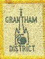 Grantham District Badge depicting the formidable spire of St. Wulframs Church.  Equally prominent is the apple symbolising the discovery of Gravity by Isaac Newton, one of Grantham's most famous sons